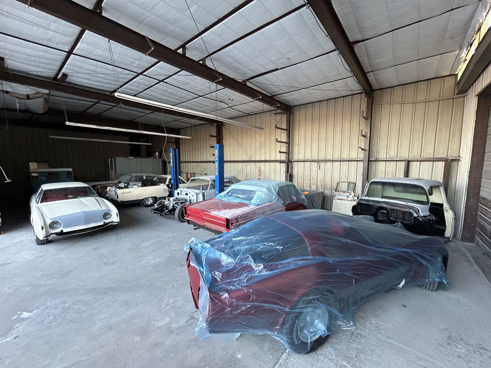 Classic cars waiting for body and paint inside Copperstate Auto Body and Paint
