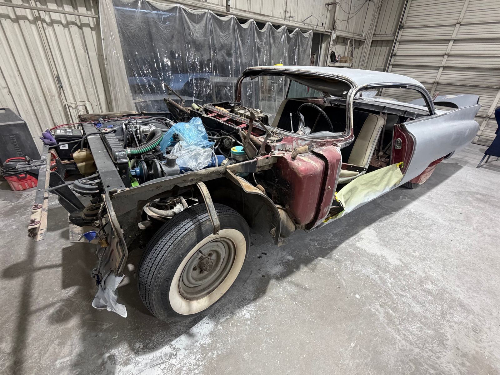 A 1959 Cadillac with its front end taken apart for bodywork