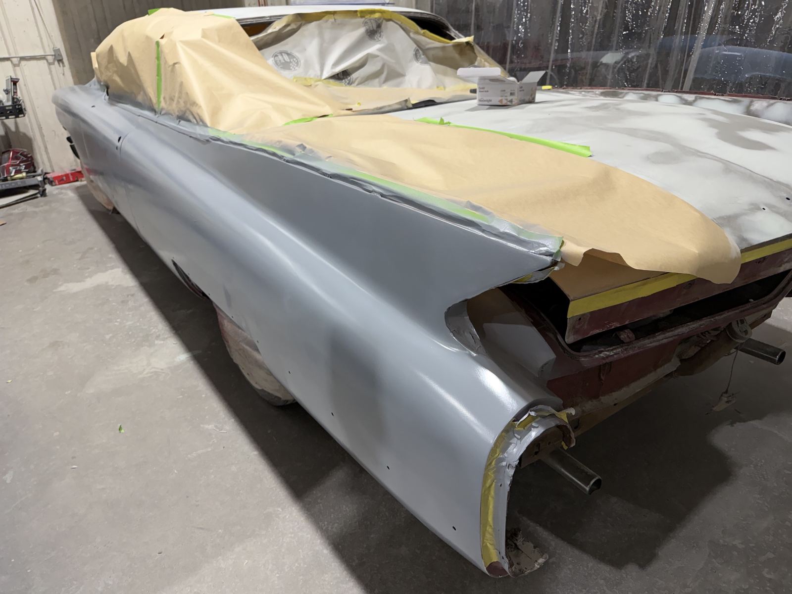 The tail fin of a 1959 Cadillac in fresh primer