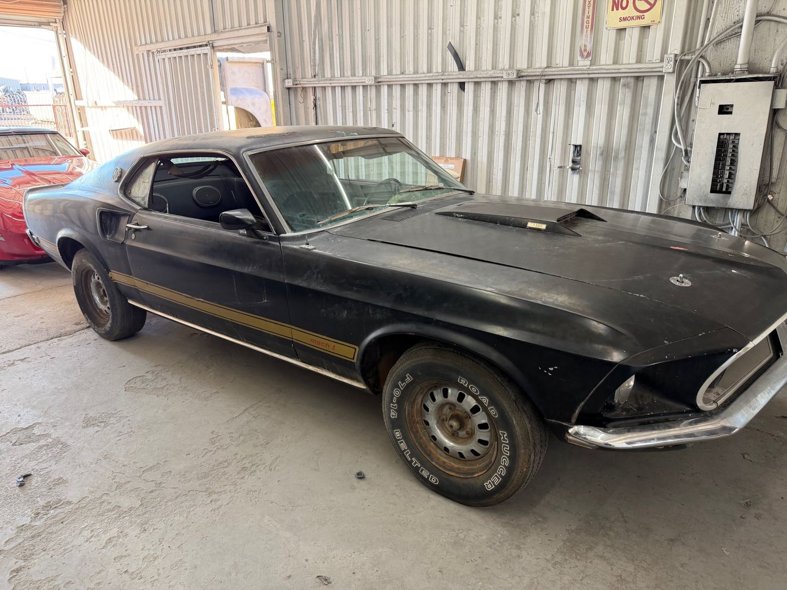 A black 1969 Mustang Mach 1 before restoration