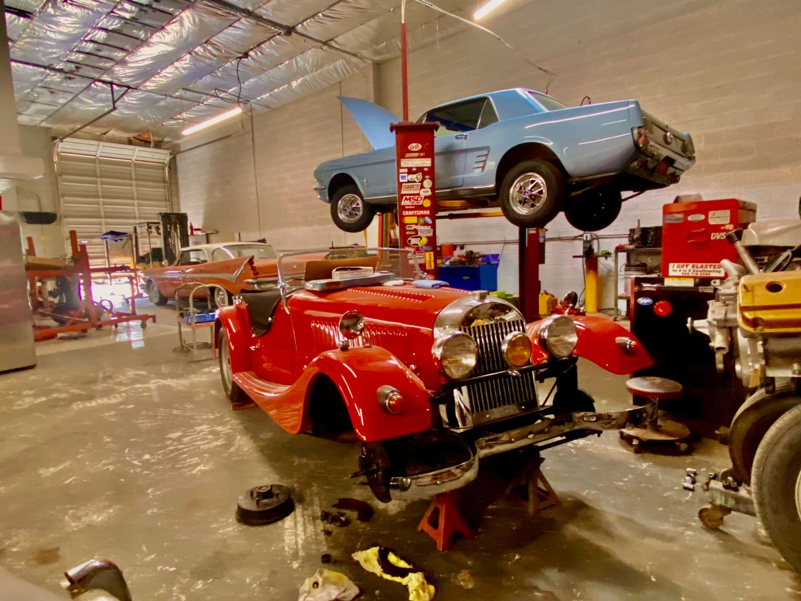A Morgan roadster, a Mustang on a lift and a finned classic in the Phoenix shop
